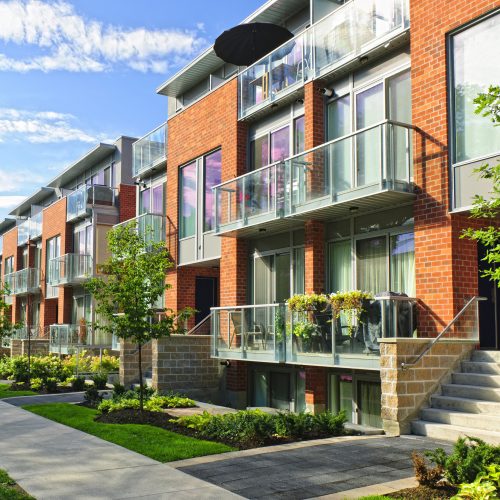 Modern town houses of brick and glass on urban street Modern town houses of brick and glass on urban street